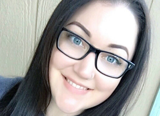 Person wearing glasses with a neutral background